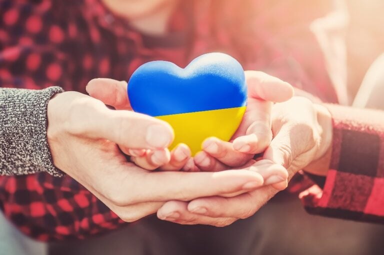 Hands holding a heart in Ukrainian colours